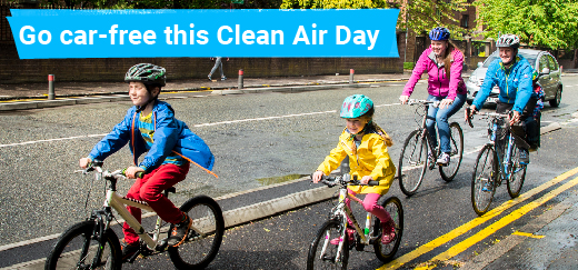 Adults and children riding their bikes with text in image that reads: Go car-free this Clean Air Day