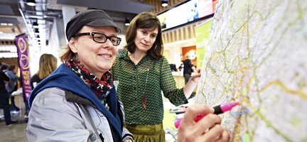 Picture of a woman highlighting a map