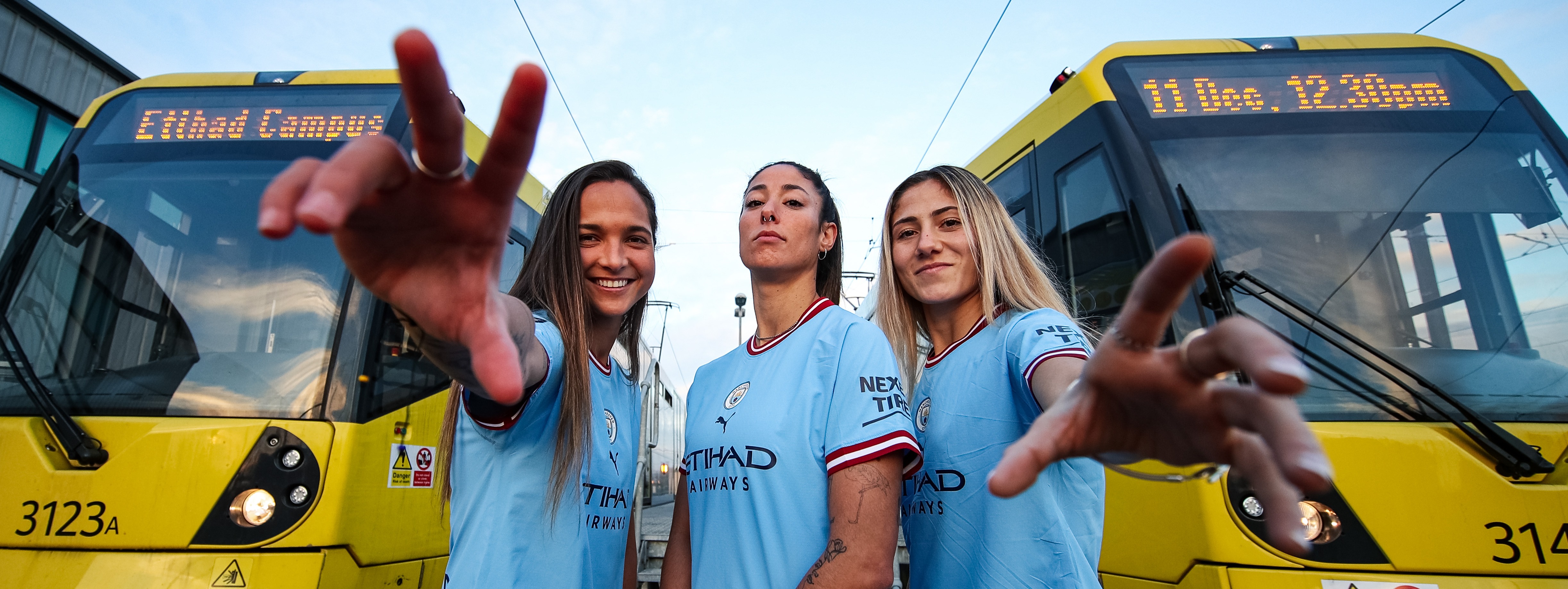 Manchester city womens team with metrolink trams