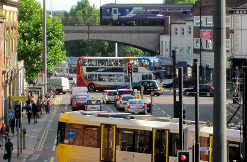 Tram bus and train crossing London Road