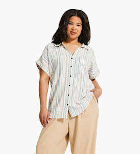 Plus sized woman model wearing a striped linen-blend top with beige pants