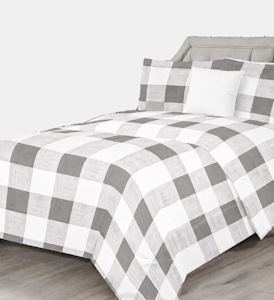 A white and grey plaid comforter set on a double bed.