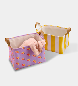 Two fabric storage bins, one is purple with a grapefruit print and the other is yellow and white stripes.