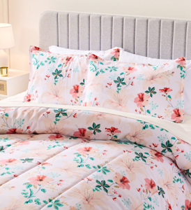White comforter set with pink and green floral print