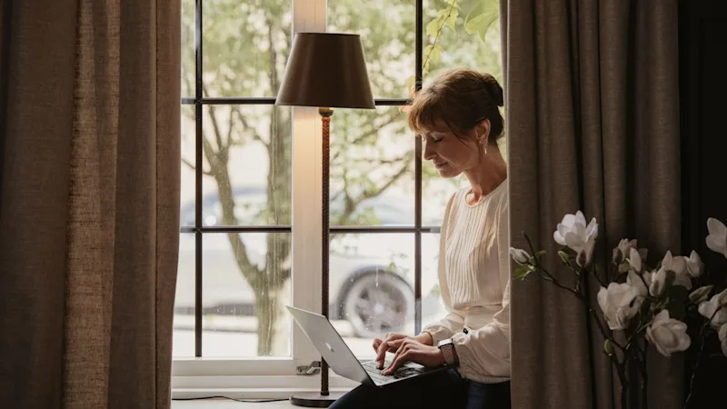 Woman working from a window at Home Hotel