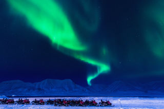 northern-lights-snowmobiles-svalbard.jpg