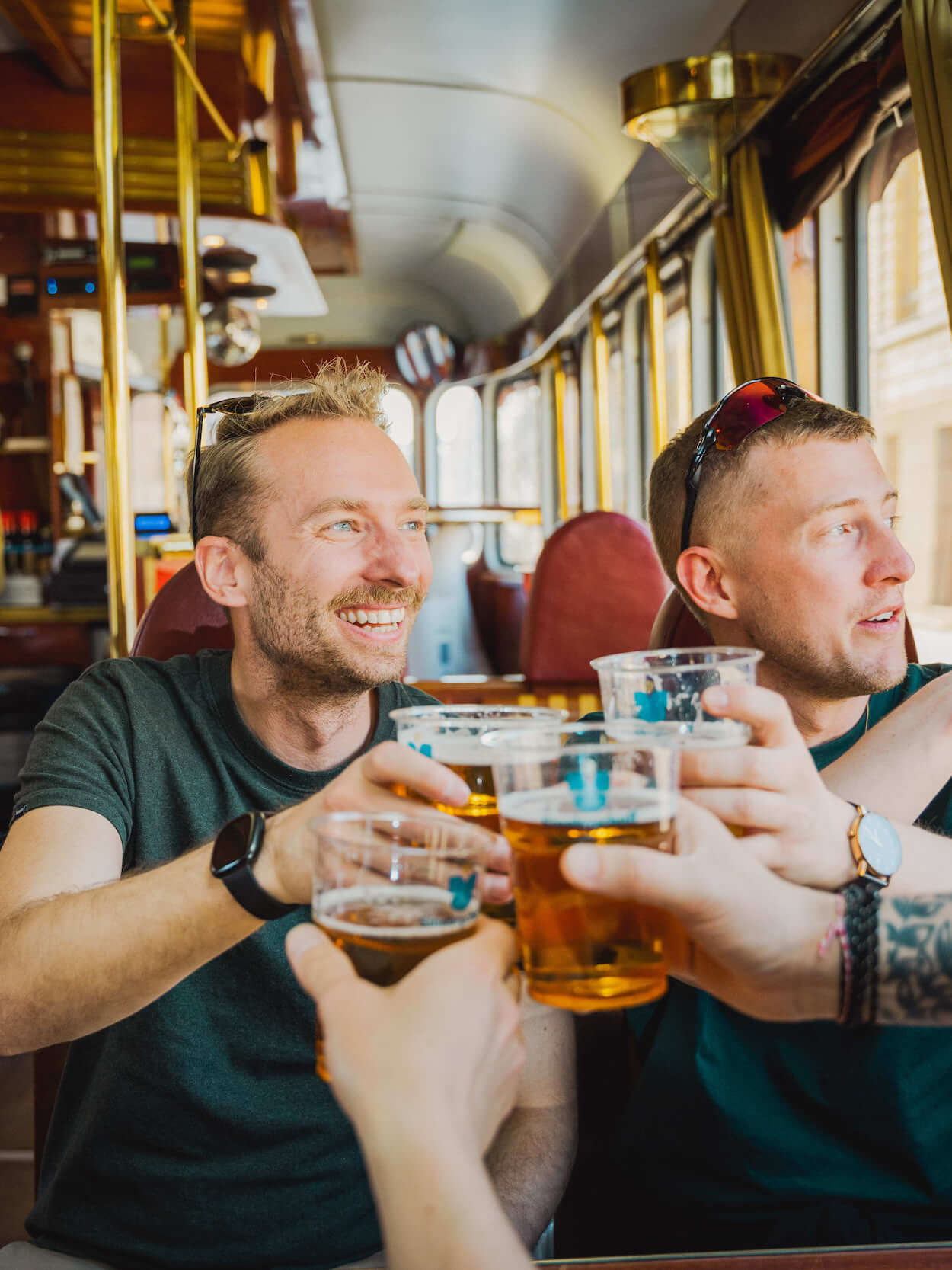 Guys sitting on the tram and pub SpåraKOFF in Helsinki pointing out of the window.