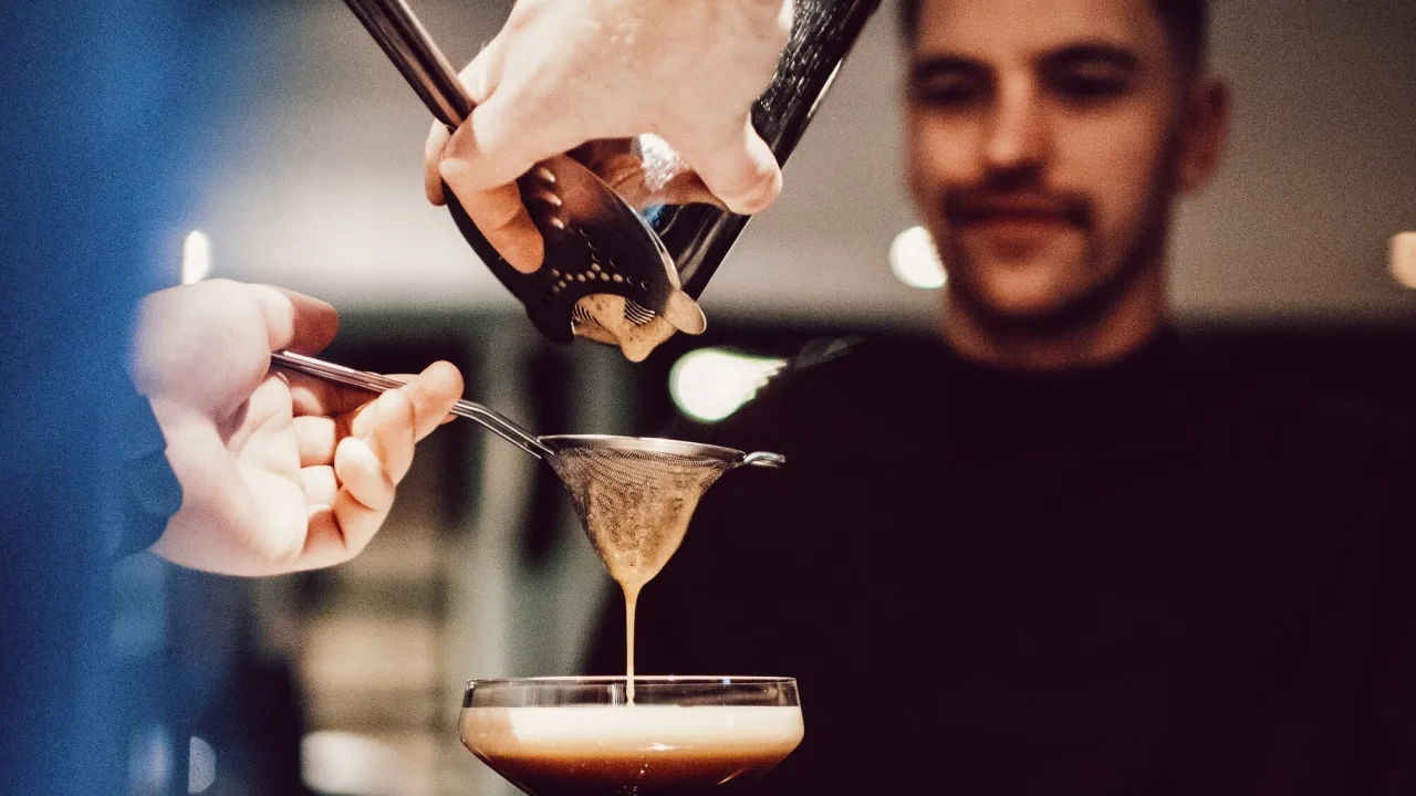 Bartender pouring up an espresso martini at restaurant The Social Bar & Bistro.