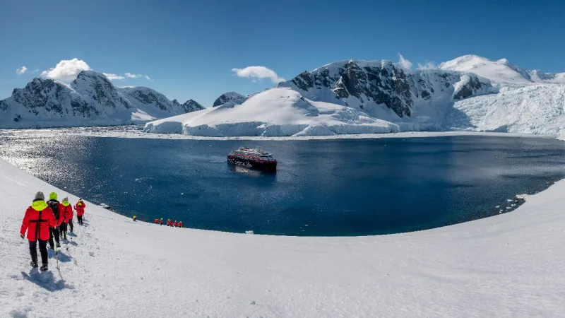 People in the beautiful Antarctica going back to Hurtigruten ship