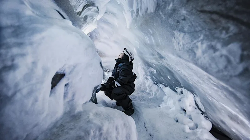 Woman in ice cave on Svalbard