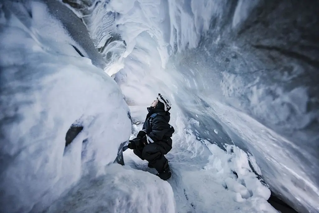 Woman in ice cave on Svalbard