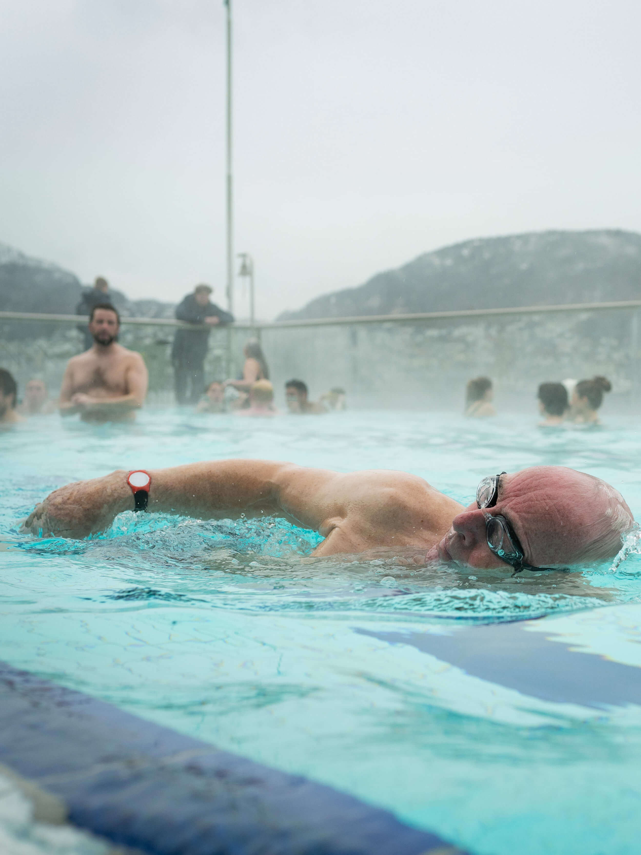 A man swimming in a warm pool at Nordnes Sjøbad in Bergen, Norway.