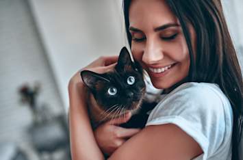 woman holding cat that's getting ready to get spayed