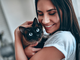 woman holding cat that's getting ready to get spayed