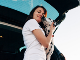 woman in car with dalmatian
