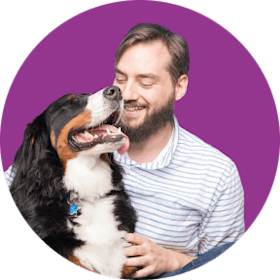man petting his happy dog