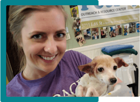 Embrace employee holding a shelter puppy