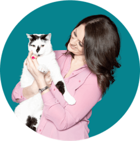 a happy woman holding her cat
