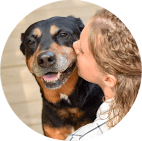 Pet parent kissing her dog