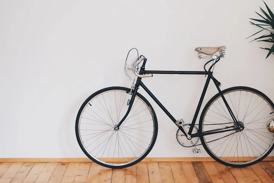 bicycle | black fixed-gear bike beside wall