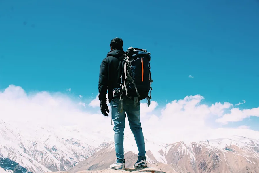 man standing on top of mountain | man standing on top of mountain