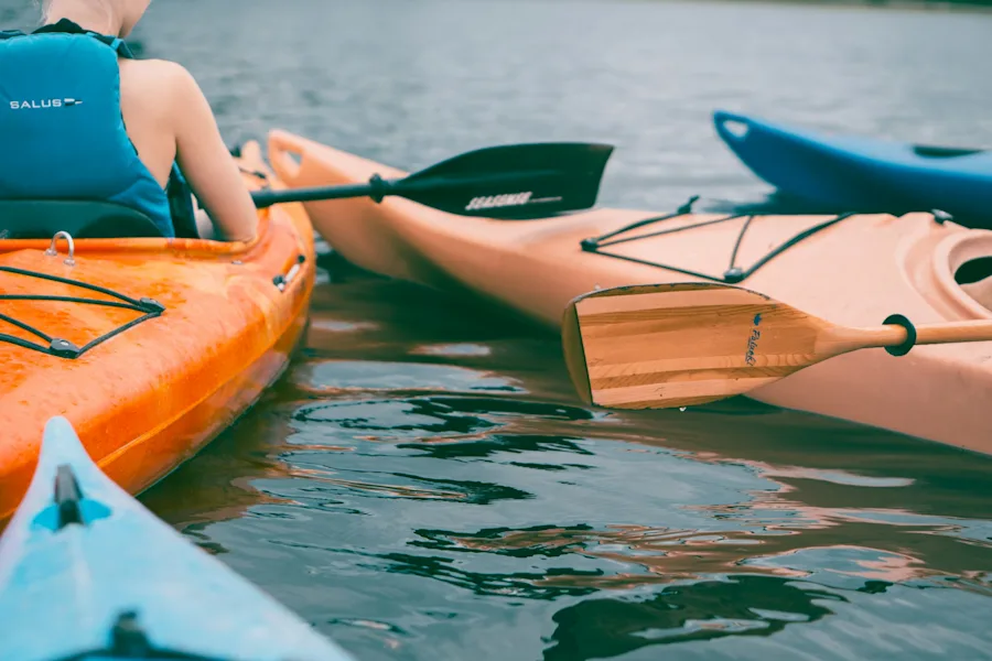 person riding on kayak | person riding on kayak
