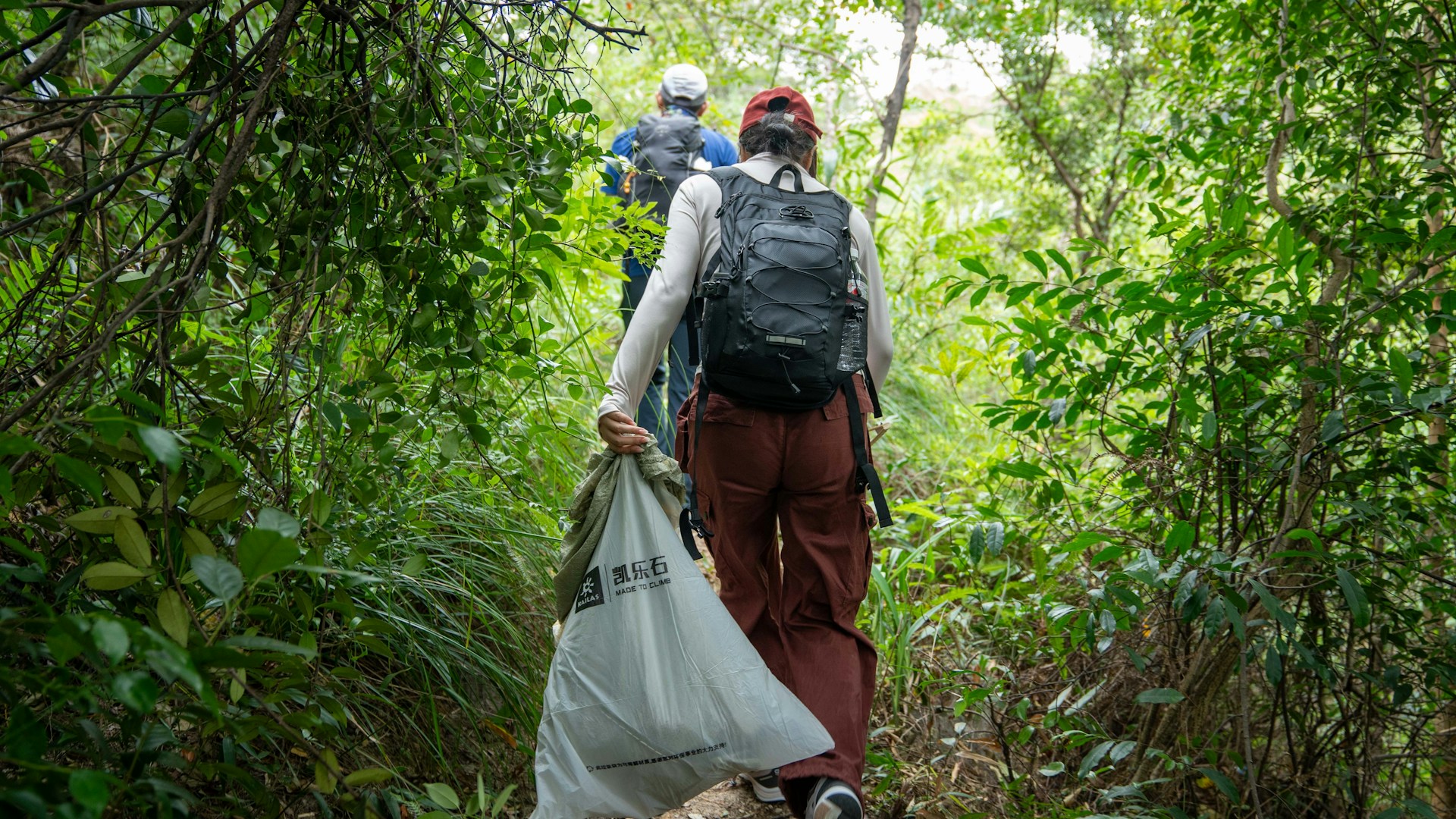 backpackers picking up trash
