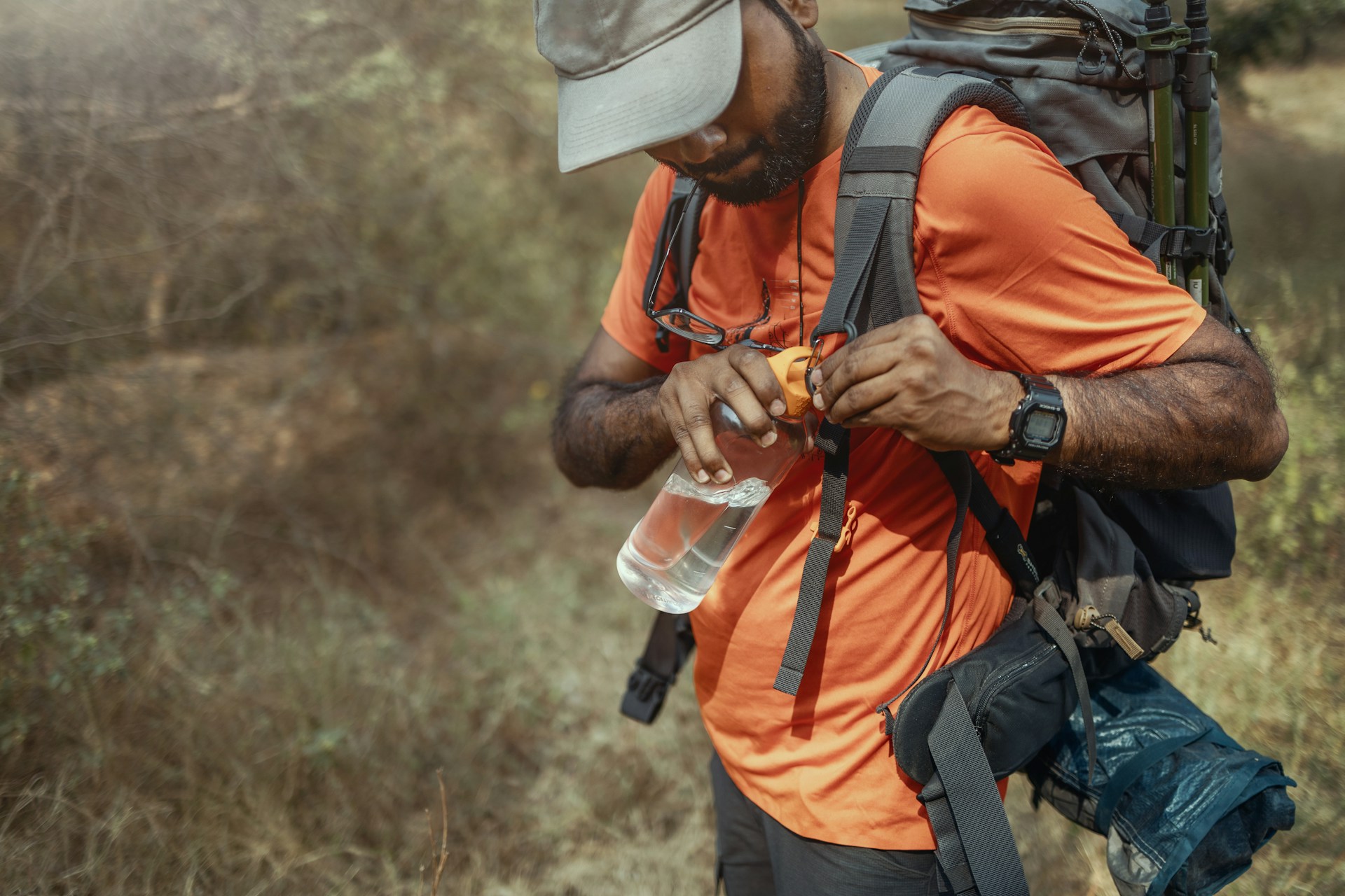 backpacker holding a water bottle
