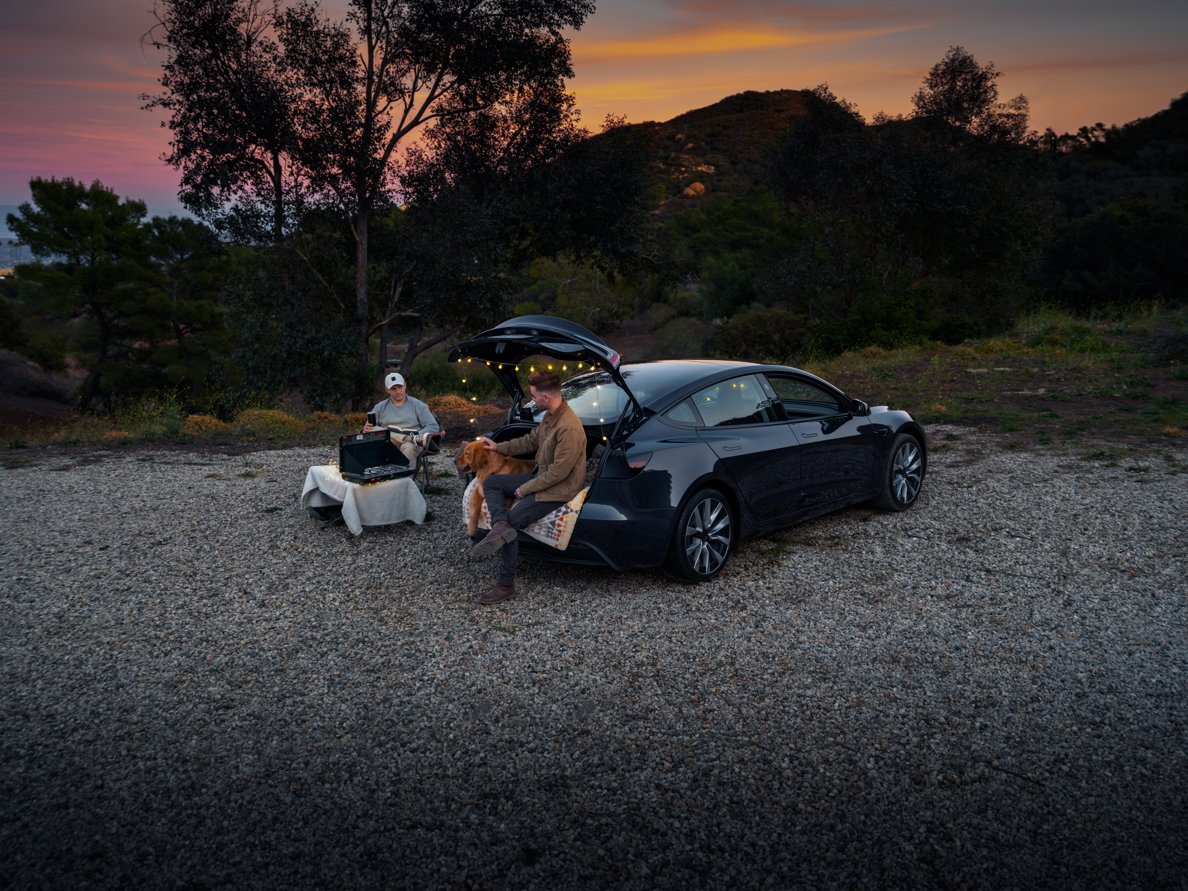 Two men camping with model 3