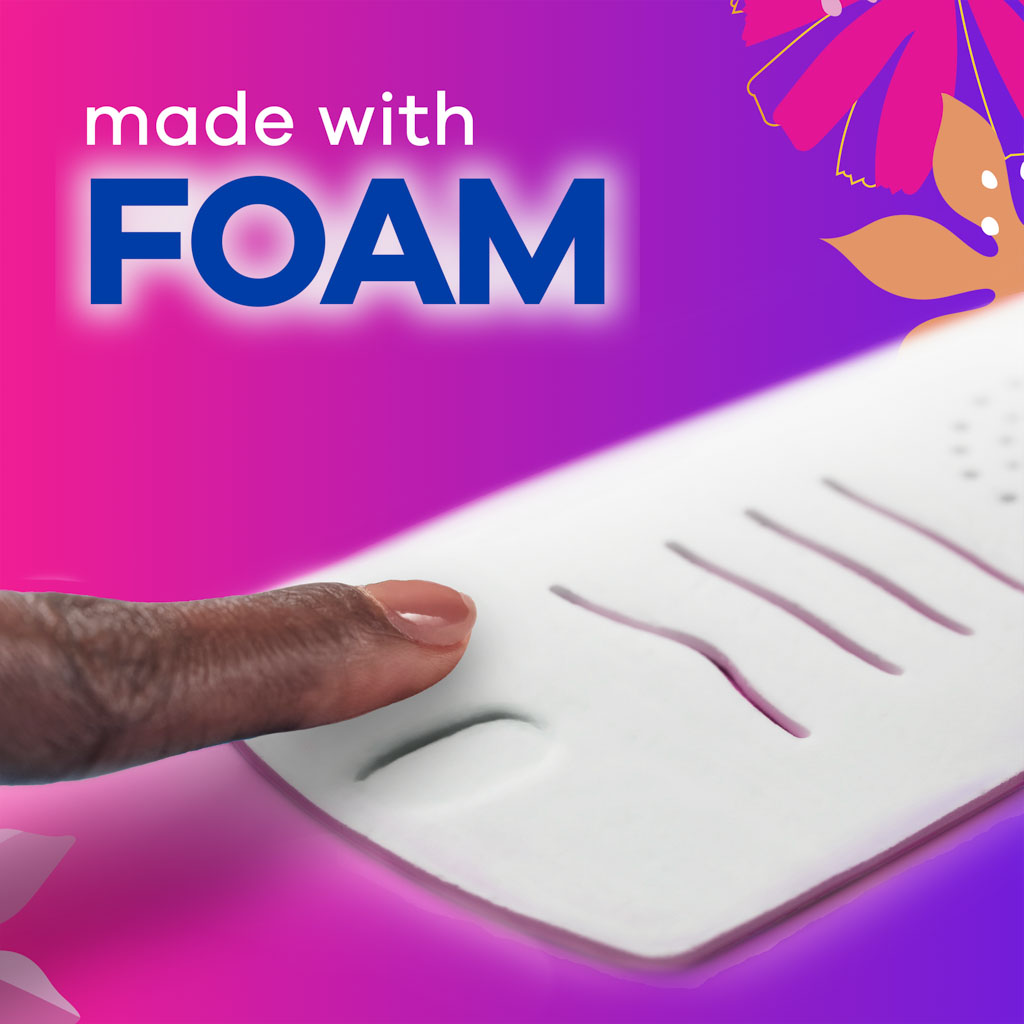 Close-up of a finger pressing a foam-based sanitary pad with text highlighting ‘made with foam’ on a vibrant pink and purple background
