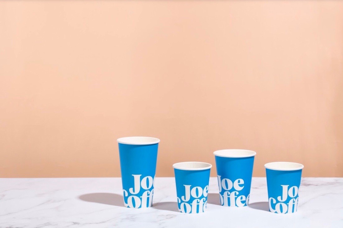 Coffee cup against blue background