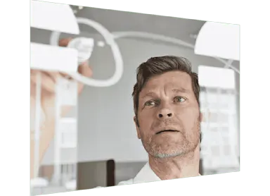 Man drawing on glass whiteboard