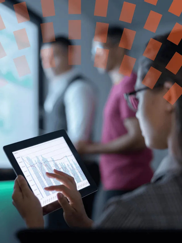 Businesswoman viewing graphs on digital tablet in business meeting