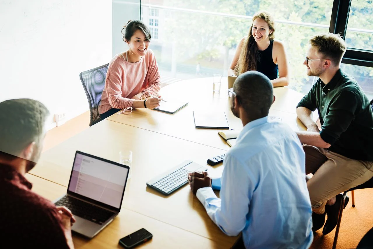 Group of five creative worker brainstorming in the office