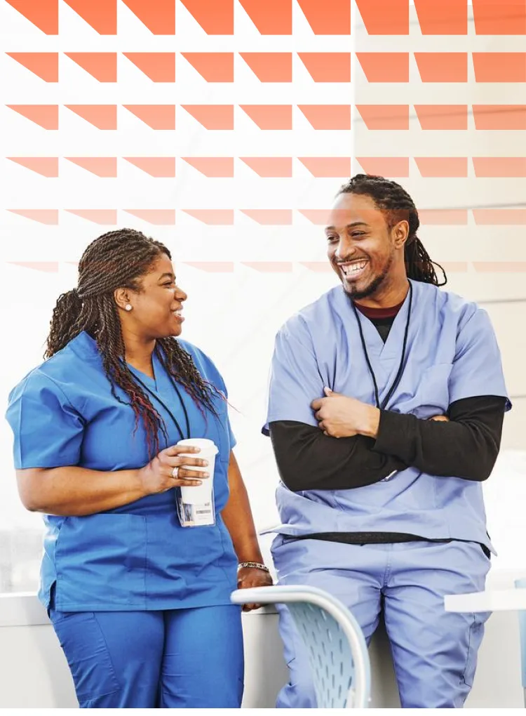 Male and female nurse talking in hospital lounge