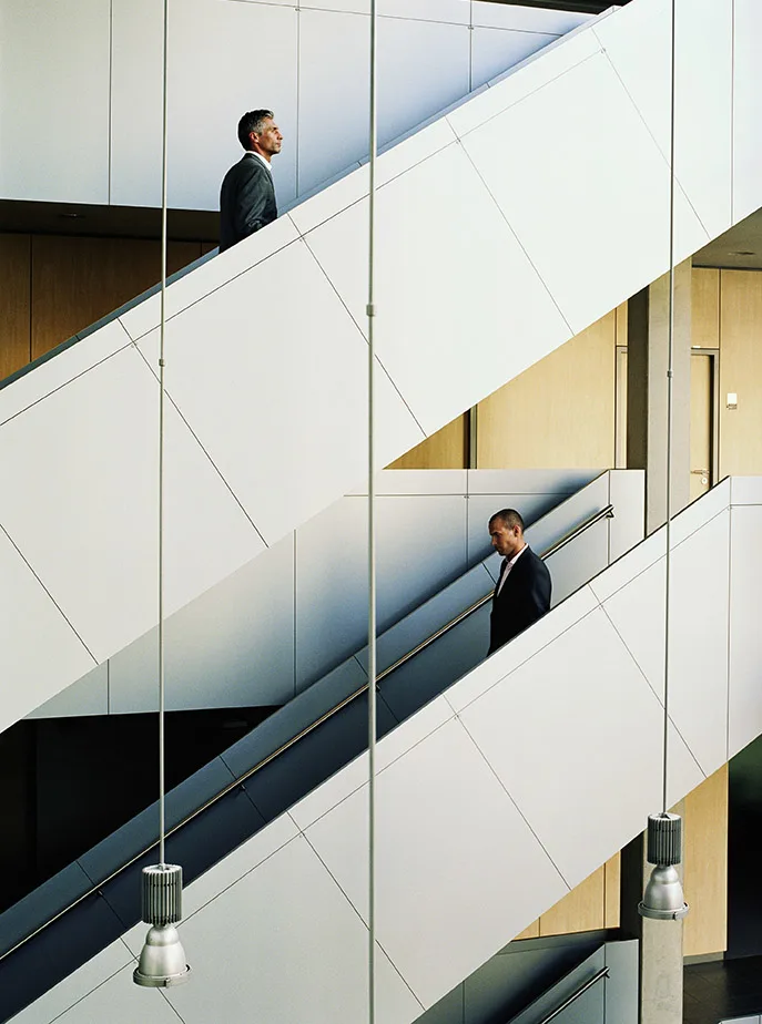 Men walking up and down office steps