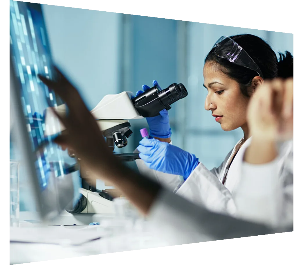 Scientist using microscope to view sample