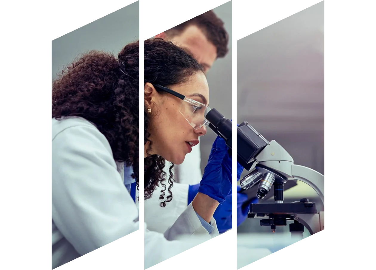 Side view of female scientist looking at test sample through microscope in laboratory