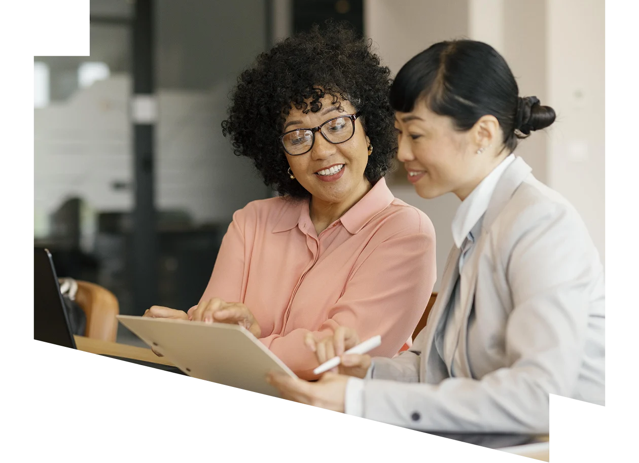Businesswoman and business man reviewing paperwork together