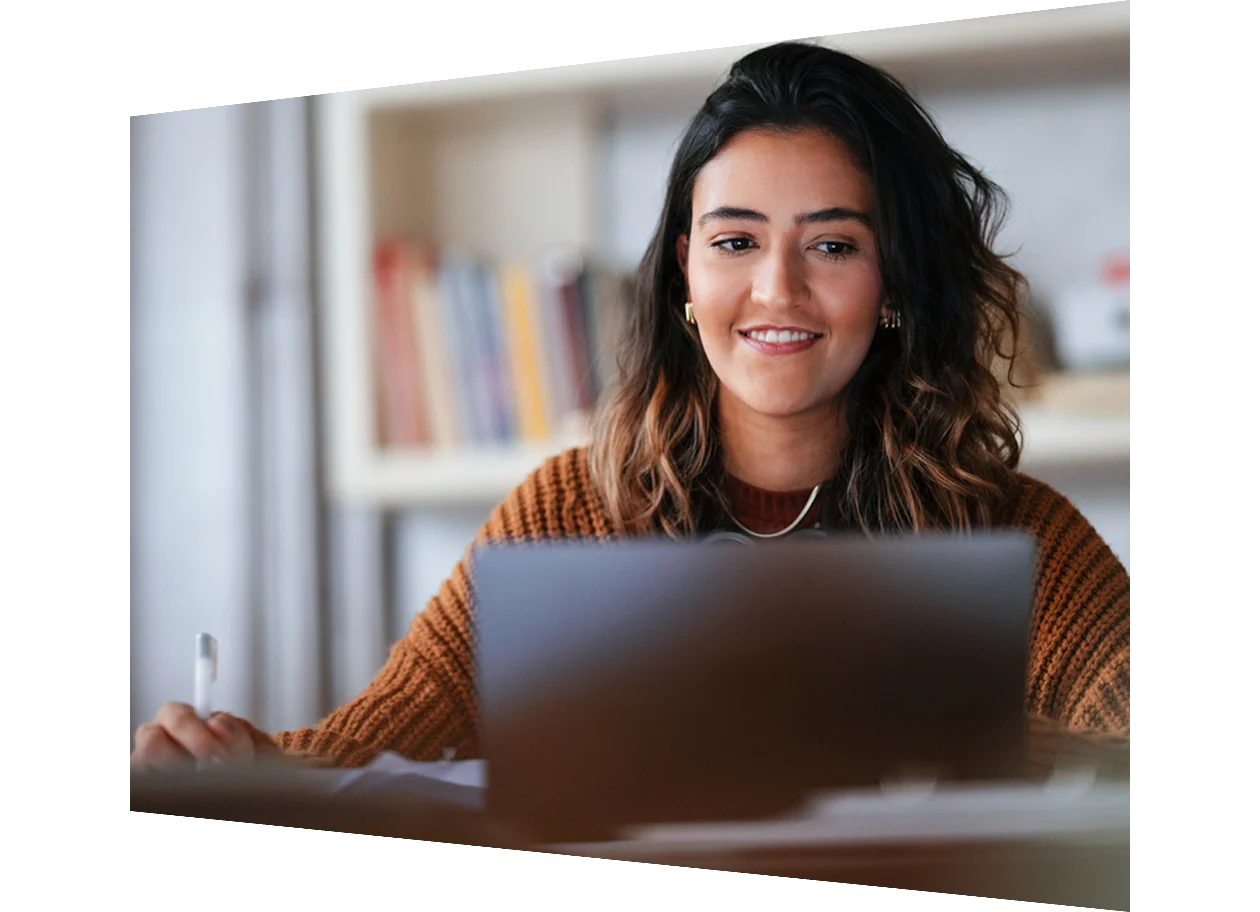 Student sitting in library using a tablet
