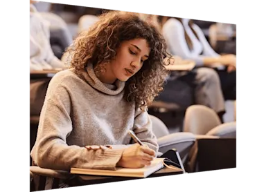 Student writing an exam at the university