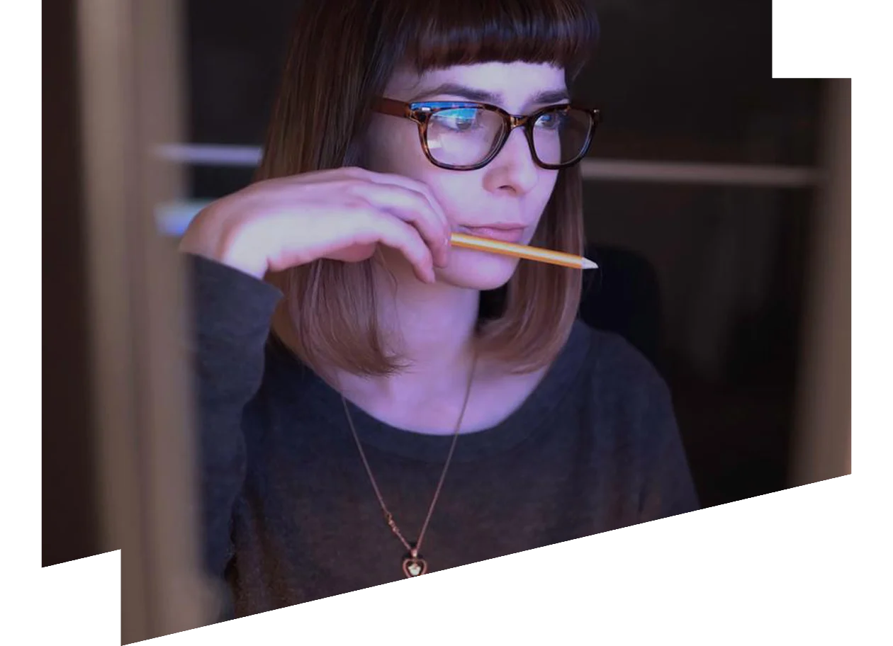 Young woman staring intently at a computer monitor
