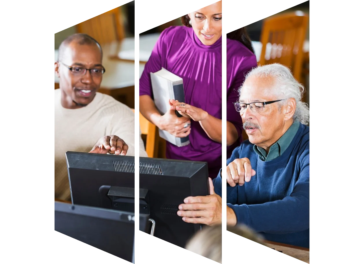 College professor looking at laptop with students