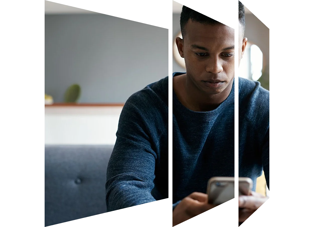 Seated young man looking at his phone