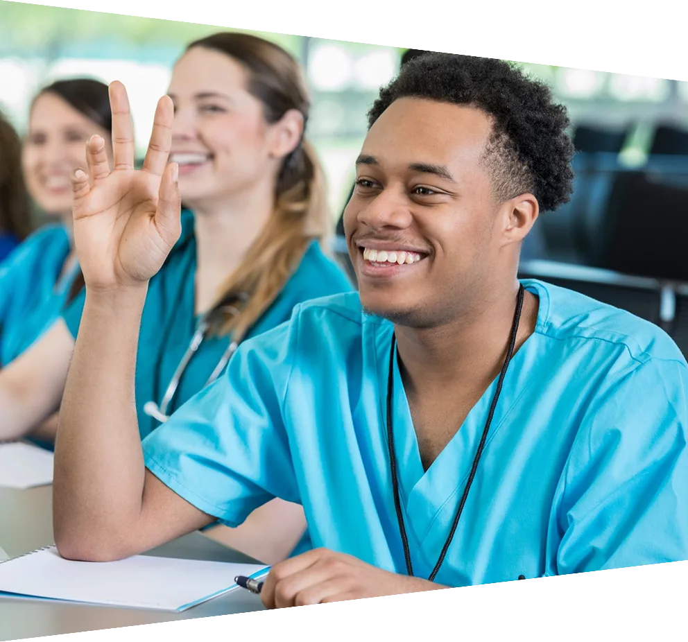 Attentive young African American male nursing student listening to professor in class