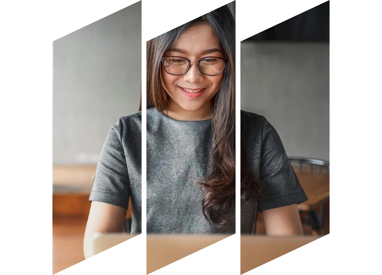 Young female studying on laptop taking notes
