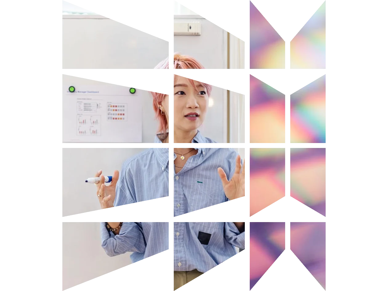 Professor speaking to class with whiteboard in the background