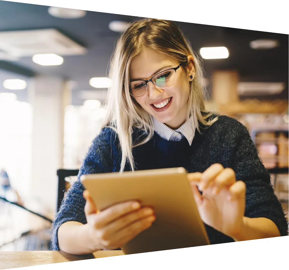 Female student studying on digital tablet in library