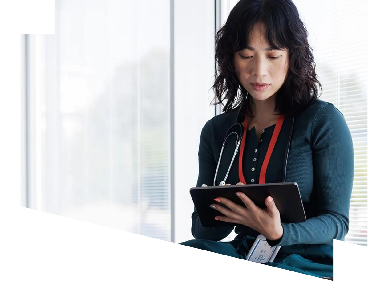 Female healthcare professional looking at a digital tablet