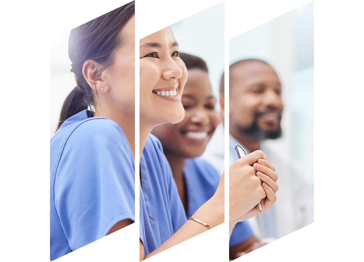 A smiling female nurse wearing scrubs